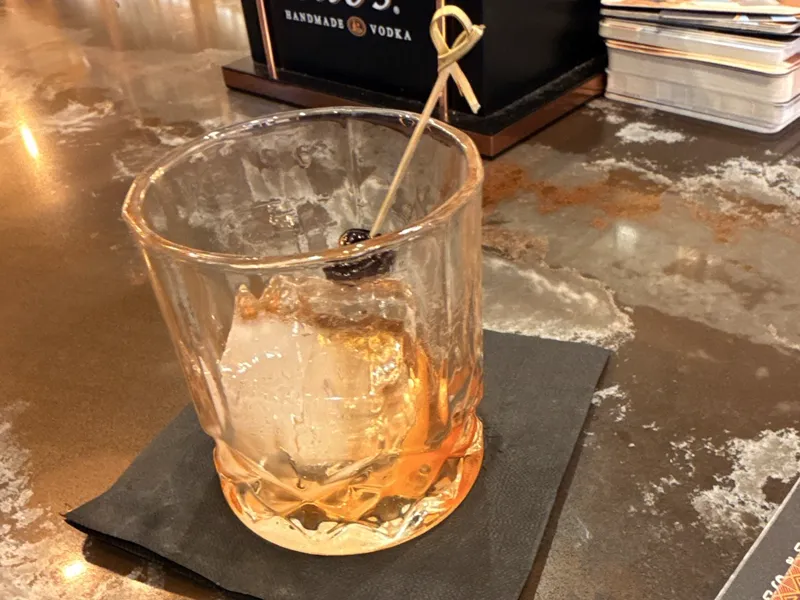 A whiskey glass on a bar