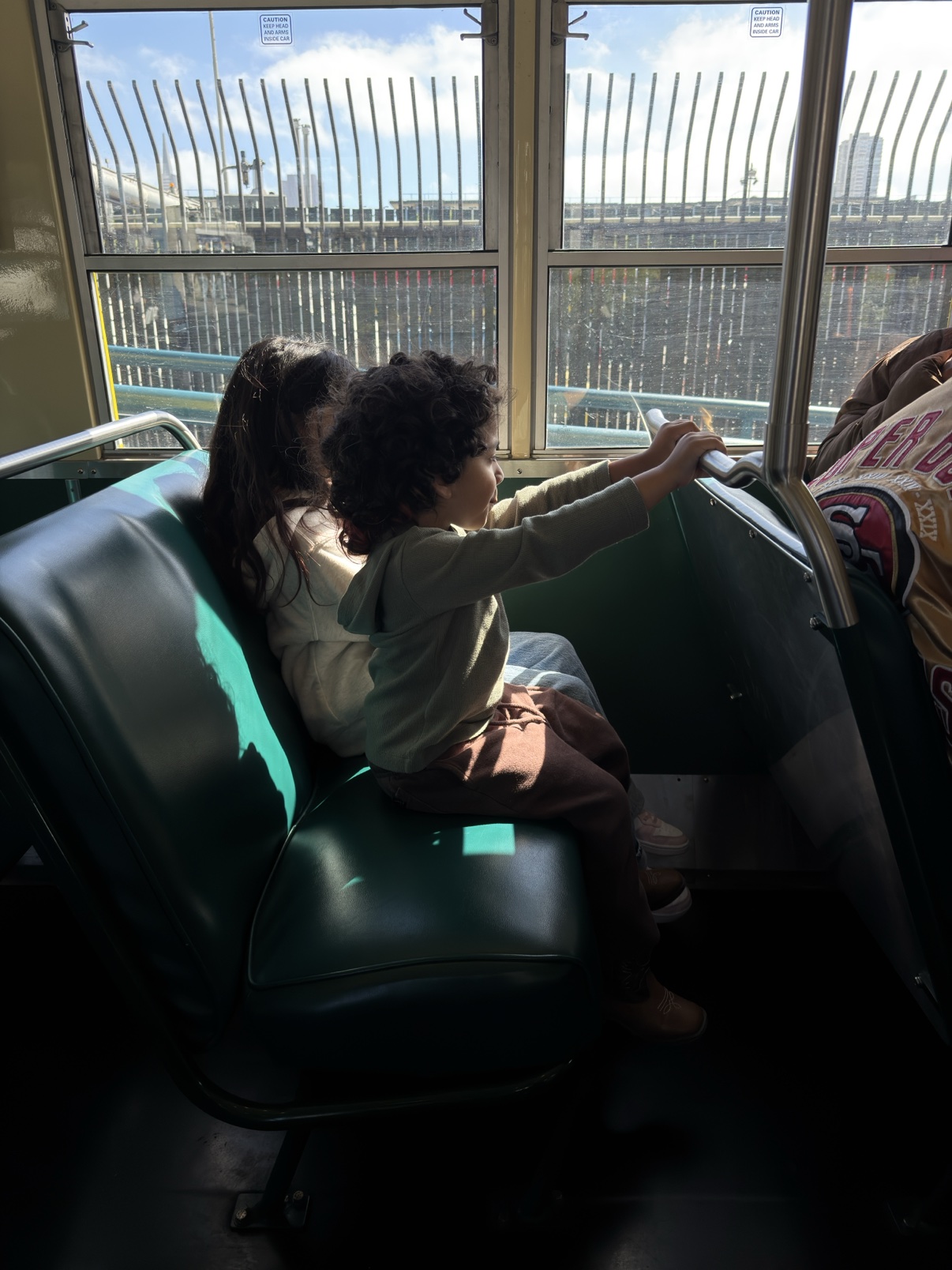 My niece and nephew riding a San Francisco cable car