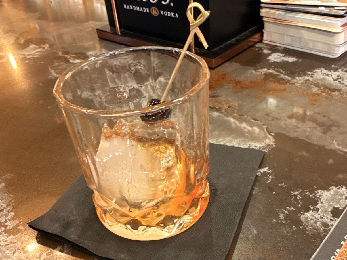 A whiskey glass on a bar