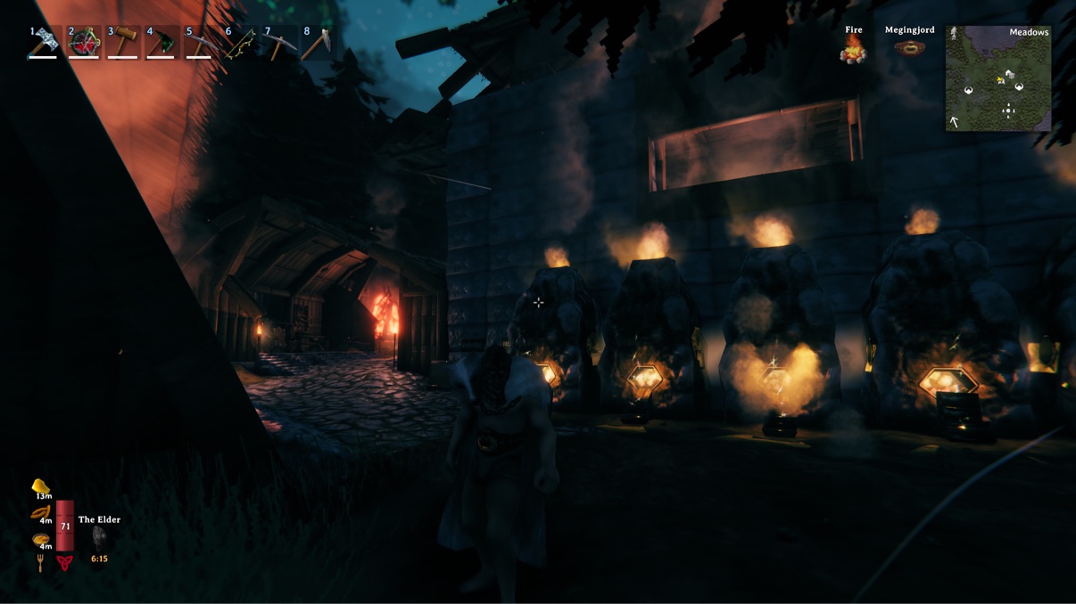 Blast furnaces glowing at night in our Valheim base